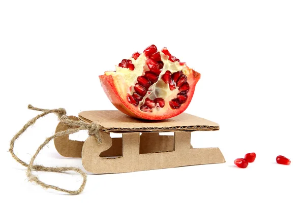 Pomegranate on a sled on white background. — Stock Photo, Image