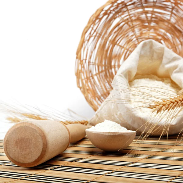 Flour and wheat grain with wooden spoon. — Stock Photo, Image