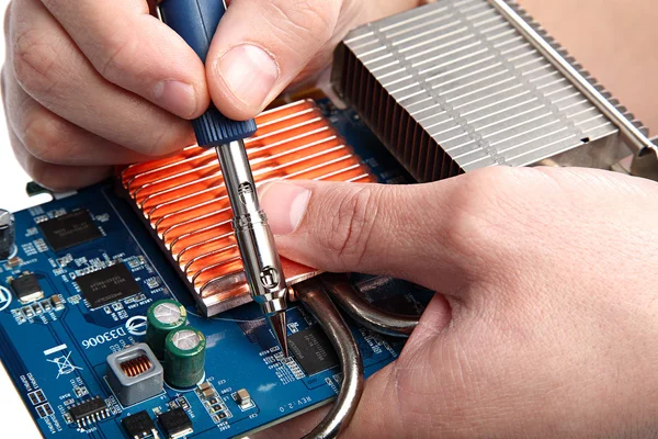 Soldering iron in hand and electric board on a white background. — Stock Photo, Image