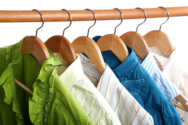 Fashion clothing on hangers at the show on white background. — Stock Photo, Image