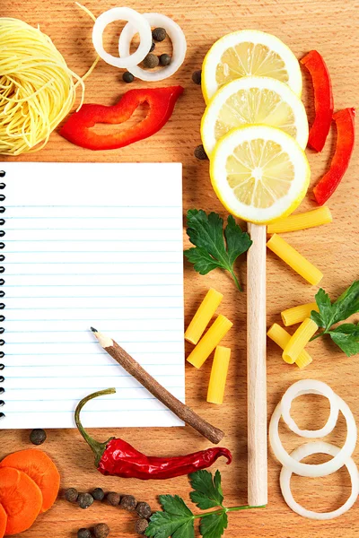 Notebook for recipes, vegetables and spices on wooden table. — Stock Photo, Image