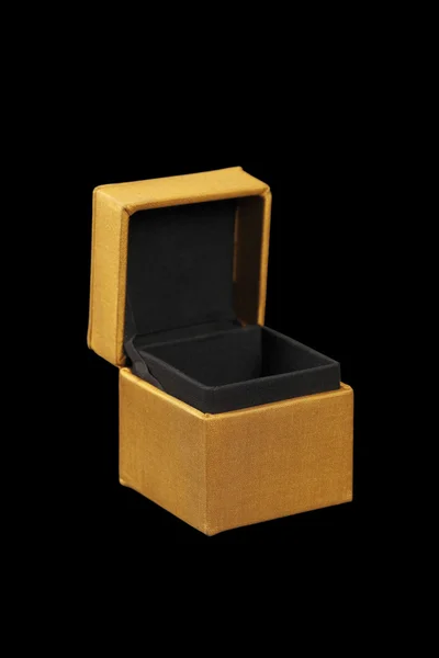 Yellow silk box on dark background — Stock Photo, Image