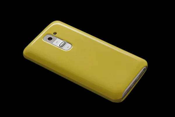 Żółty telefon inteligentny koncepcja na ciemnym tle — Zdjęcie stockowe