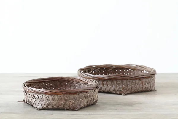 Pair flat basket on wooden table — Stock Photo, Image