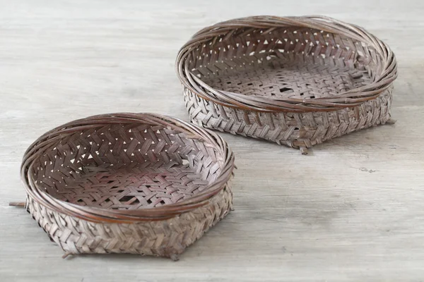 Pair flat basket on wooden table — Stock Photo, Image