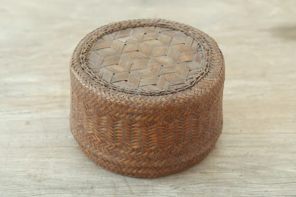 Round basket on wooden table — Stock Photo, Image