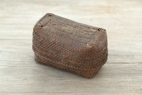 Small brown basket on wooden table — Stock Photo, Image