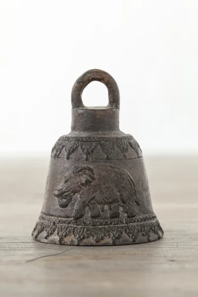 Antique bell on wooden table — Stock Photo, Image