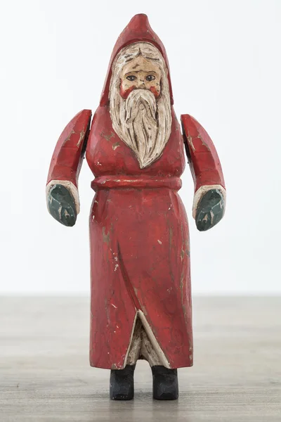 Antique wooden santa on wooden table — Stock Photo, Image
