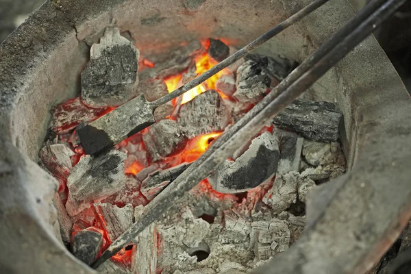 Burning iron in stove — Stock Photo, Image