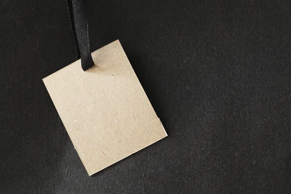 Paper tag on black paper — Stock Photo, Image