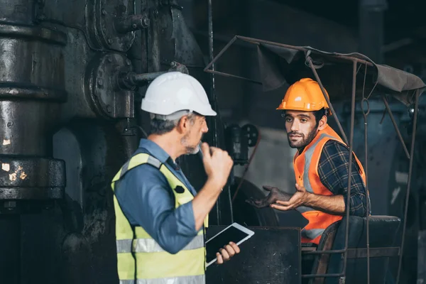 industrial factory with men at work concept, professional engineers foreman inspectors talking in business occupation job teamwork with team, construction managers working in manufacturing technology job