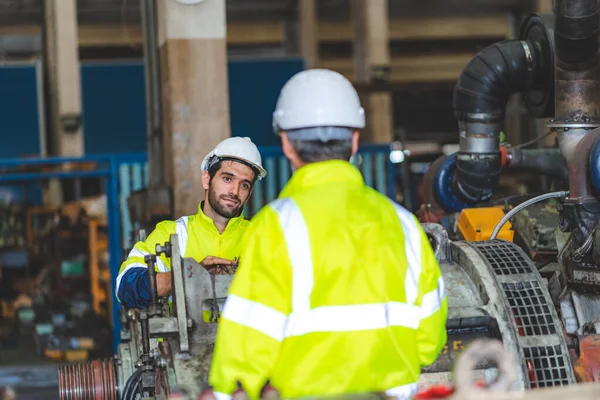 industrial factory with men at work concept, professional engineers foreman inspectors talking in business occupation job teamwork with team, construction managers working in manufacturing technology job