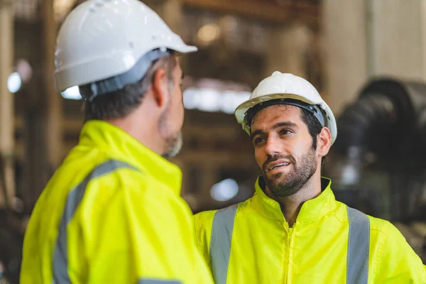 industrial factory with men at work concept, professional engineers foreman inspectors talking in business occupation job teamwork with team, construction managers working in manufacturing technology job