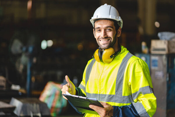 professional technician engineer with safety hard hat working to maintenance construction equipment in industrial factory, inspection man having manufacturing occupation job of production technology