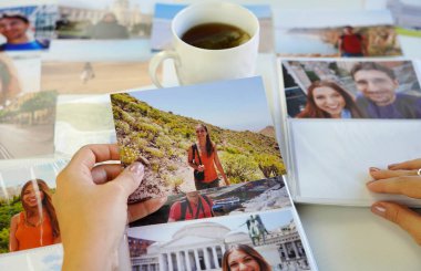 Kız basılı fotoğraflarına bakıyor, bir günlük dinlenme nostaljisini hatırla.