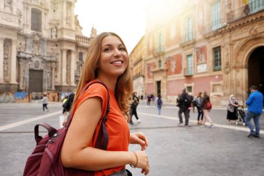 Beautiful excited school exchange girl visiting Europe within the exchange program clipart