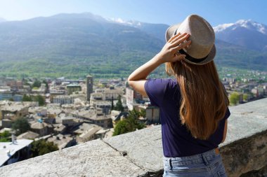 Beautiful girl enjoying panoramic view of Sondrio old town, Valtellina, Italy