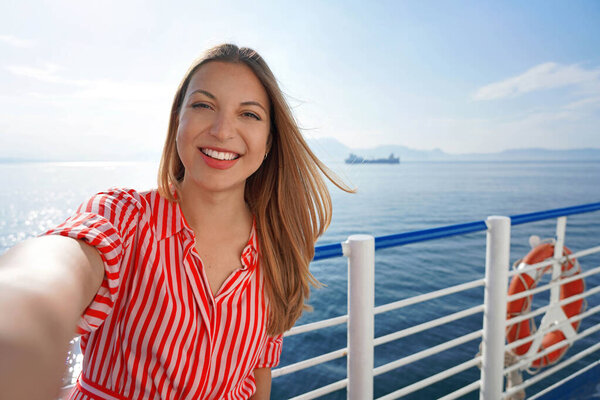 Cruise ship holiday travel vacation. Smiling tourist girl taking selfie on holidays destination on cruise liner.