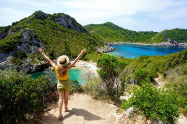 Grateful woman with arms up in front of a spectacle of nature