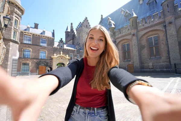 Self portrait of student girl in the courtyard of the Binnenhof complex of buildings in The Hague, Netherlands