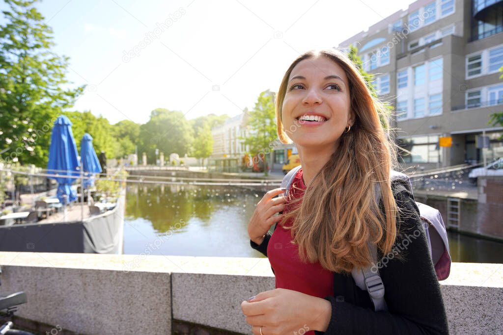 Beautiful excited school exchange girl visiting Europe within the exchange program