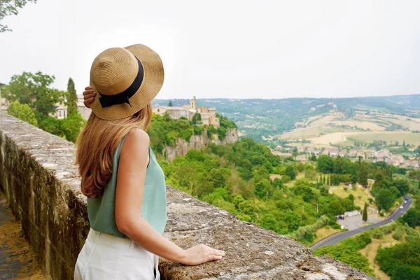 Tourist woman in the peaceful town of Orvieto enjoying calm landscape of Umbria hills in central authentic Italy