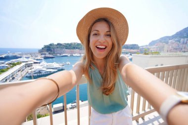 Beautiful tourist girl takes self portrait in Monte-Carlo, Monaco