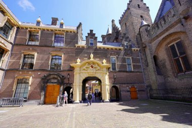 THE HAGUE, NETHERLANDS - JUNE 9, 2022: Binnenhof parliament building view of the gate entrance of courtyard, The Hague, The Netherlands