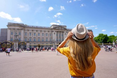 Back view of young tourist woman visiting London, United Kingdom