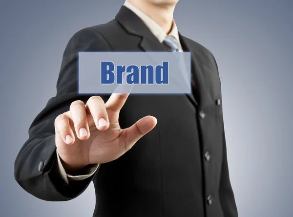 Businessman hand pushing brand button — Stock Photo, Image