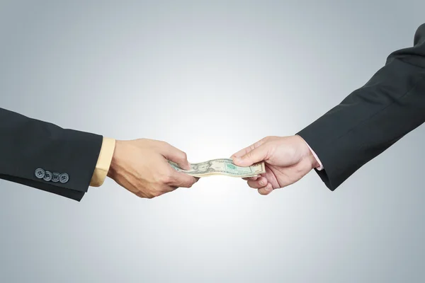 Businessman hand and money to other for corruption concept on wh — Stock Photo, Image