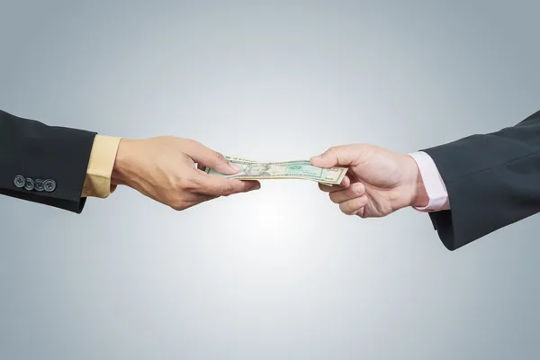 Businessman hand and money to other for corruption concept on wh — Stock Photo, Image
