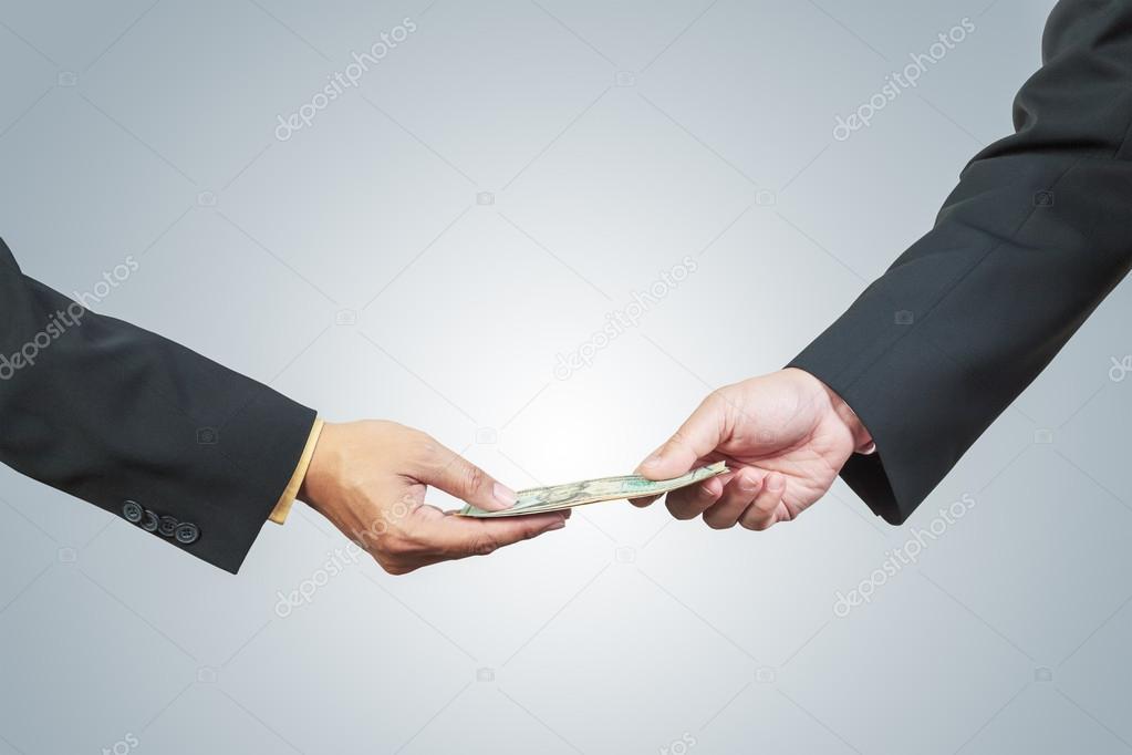 businessman hand and money to other for corruption concept