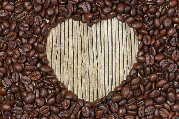 Καρδιά του καφέ σε παλιά ξύλινα φόντο — Φωτογραφία Αρχείου