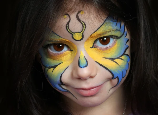 Pretty girl with face painting of a butterfly — Stock Photo, Image