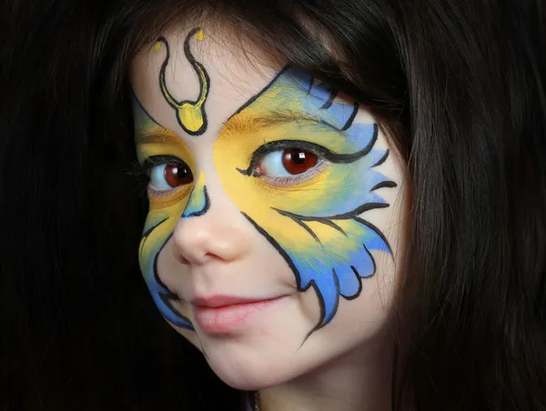 Pretty girl with face painting of a butterfly — Stock Photo, Image