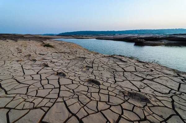 Cracked soil and pond in Sampanbok ,in Mekong River — Stock Photo, Image