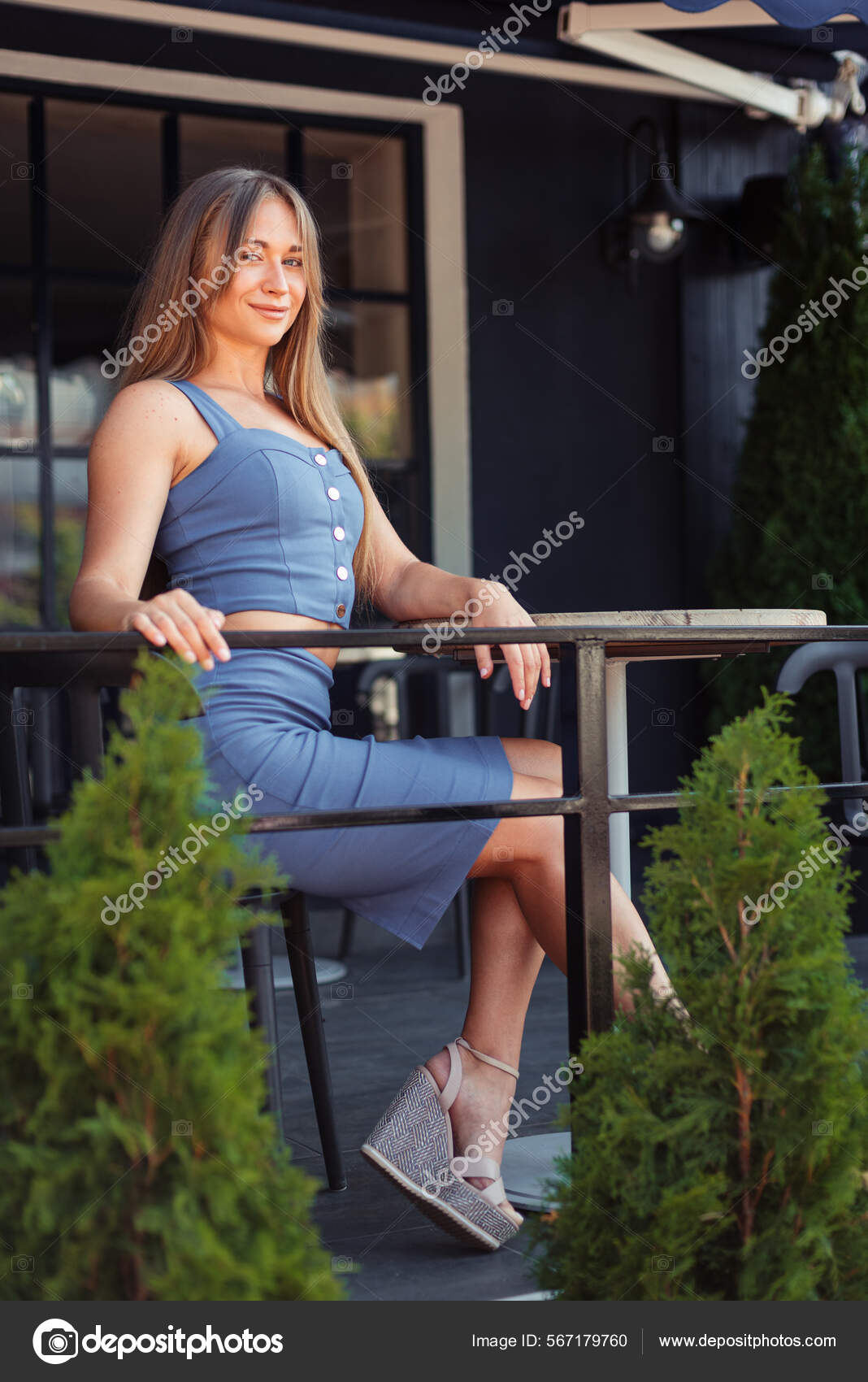 Stylish Girl Sits Sideways Table Cafe Stock Photo by ©maxfoto87 567179760