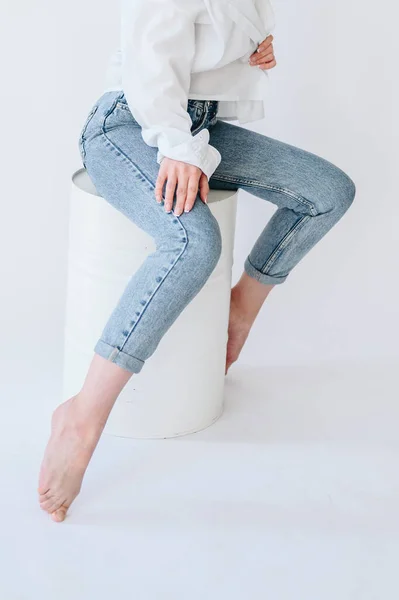 Girl Jeans White Shirt Sits Casually White Barrel Closeup Photo —  Fotos de Stock