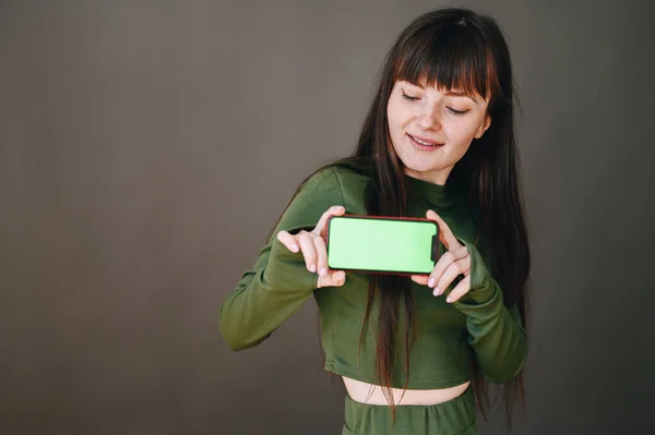 Girl Laughs Out Loud Holds Phone Both Hands Green Screen — Φωτογραφία Αρχείου