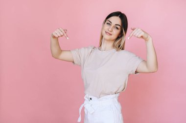 Genç bir kız ellerini kaldırmaz, mesaj buraya tıklamak, bağlantıyı takip etmek, takip etmek. Pembe izole bir arkaplanda