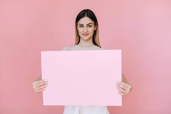 Young Woman Holding Pink Sheet Paper Her Hands Center Pink — стоковое фото