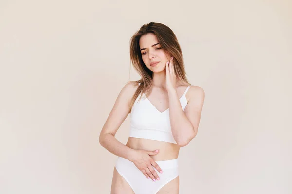 2016 Young Slender Woman White Underwear Hand Stomach Beige Background — 스톡 사진