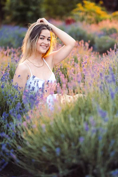 Beautiful Happy Woman in Lavender Field at Golden Hour at Sunset. Ice Evening in the Lavender Field.