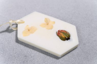 Altıgen 'de Aromatic Wax Sachet ve Kurumuş Çiçekler. Ön Manzara. Gri Beton Özgeçmişi. Hediye..