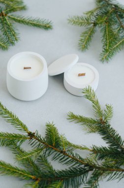 Çeşitli Boyutlarda Beyaz Mum Grubu Üst Görünüm. Gri Arkaplanda Noel Ağacı Dalları ve Mumları Düz Yerde.
