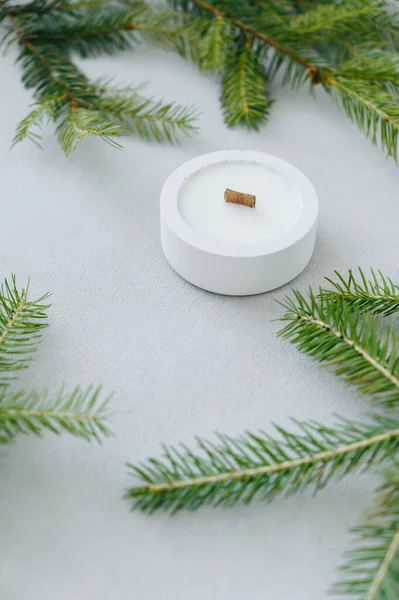 Christmas Tree Branches and Round Flat white Candlestick with Soy Candles. Copy Space. Christmas Mockup Screensaver