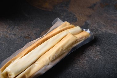 Smoked Soft Cheese Stick Vacuum Packed for Sale. Place for label. Snack for beer.