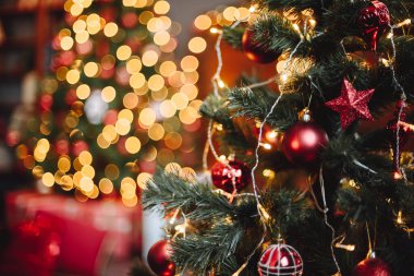 Christmas Tree with Red Christmas Toys. Background Bokeh with Yellow Lights. New Year Screensaver.